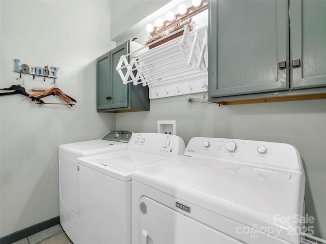 laundry area with baseboards, cabinet space, and washing machine and clothes dryer