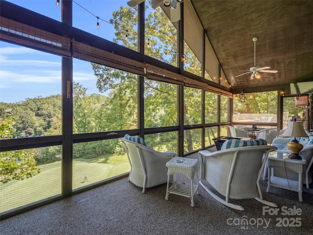 sunroom / solarium with ceiling fan and vaulted ceiling