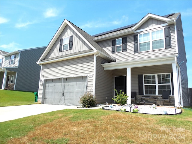 craftsman-style home featuring a garage and a front yard