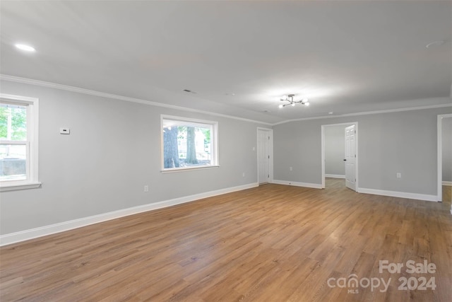 unfurnished room featuring crown molding and light hardwood / wood-style flooring