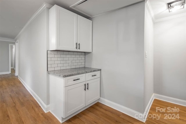 interior space featuring light wood-type flooring and white cabinetry