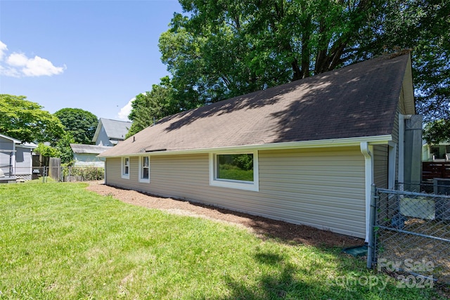 back of house with a lawn