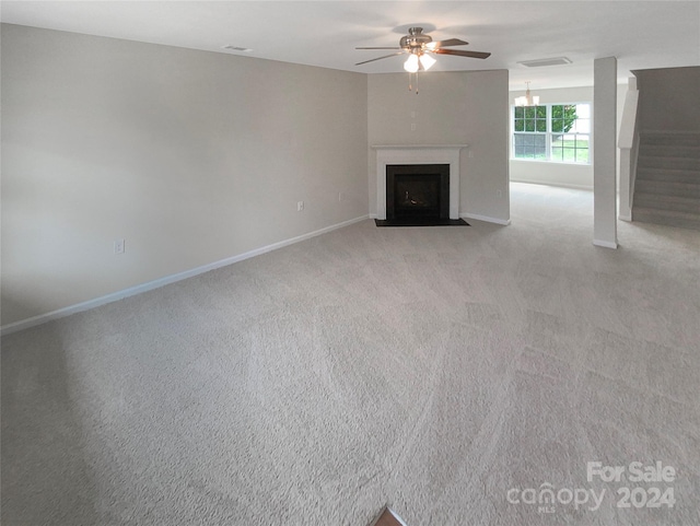 unfurnished living room featuring ceiling fan and light carpet