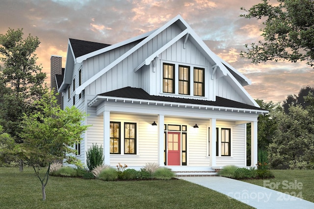 view of front of property featuring a lawn and a porch