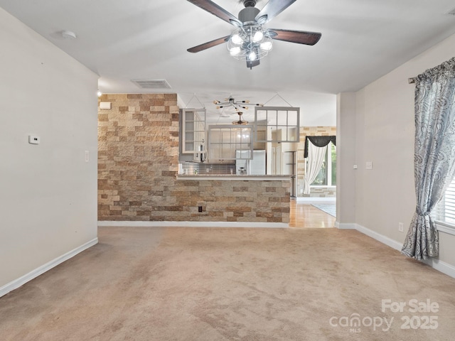 unfurnished room featuring light colored carpet and ceiling fan