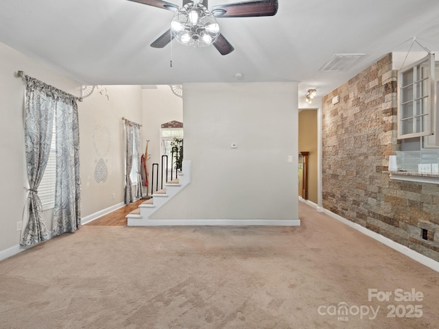 carpeted spare room featuring ceiling fan