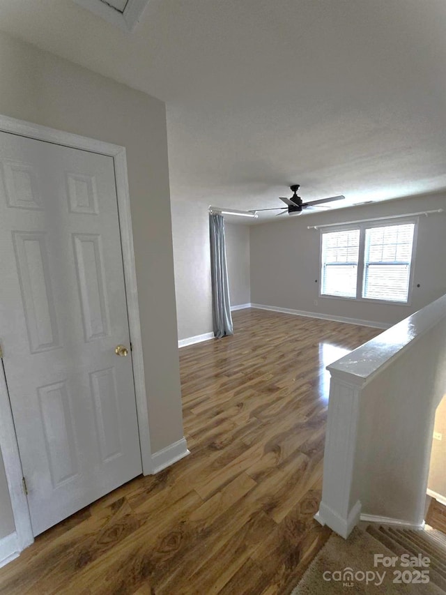 spare room featuring wood-type flooring and ceiling fan