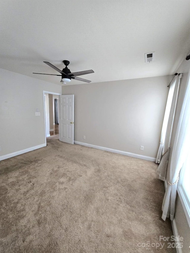 carpeted spare room featuring ceiling fan