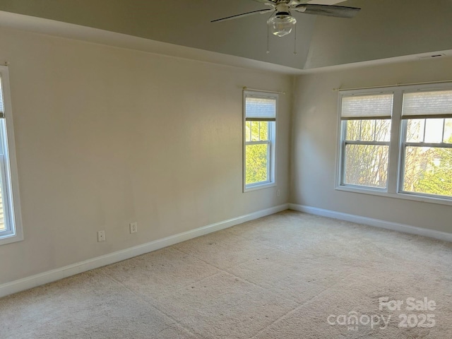 carpeted spare room with ceiling fan