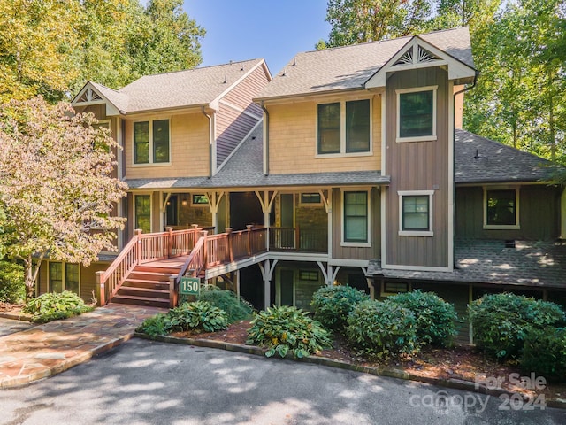 150-2 Saddle Notch Ln, Tuckasegee, NC 28783 - view of front of house with a shingled roof, board and batten siding, and stairway