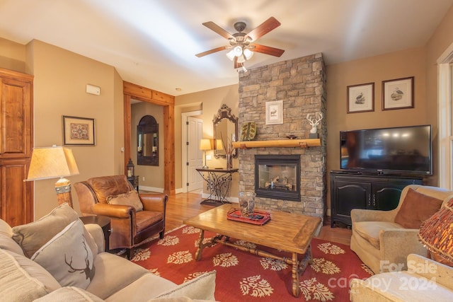 150-2 Saddle Notch Ln, Tuckasegee, NC 28783 - living room with a ceiling fan, a stone fireplace, wood finished floors, and baseboards