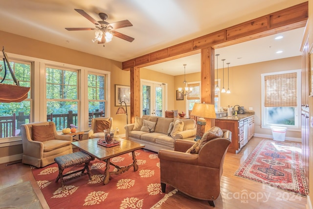 150-2 Saddle Notch Ln, Tuckasegee, NC 28783 - living area featuring light wood-style flooring, a chandelier, a ceiling fan, and baseboards