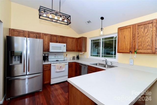 kitchen featuring pendant lighting, appliances with stainless steel finishes, sink, and dark hardwood / wood-style flooring