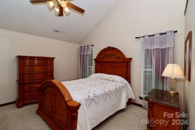 carpeted bedroom with ceiling fan and vaulted ceiling