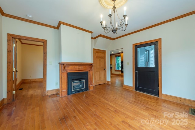 unfurnished living room featuring baseboards, light wood-type flooring, a fireplace, and a notable chandelier