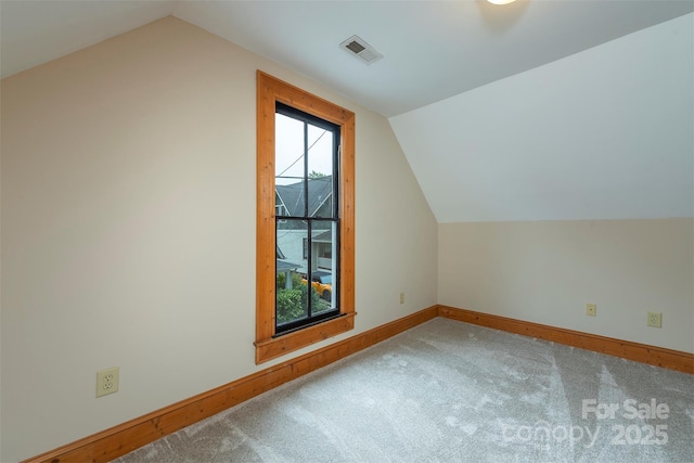 bonus room with lofted ceiling, carpet flooring, visible vents, and baseboards