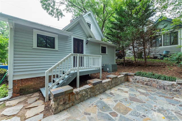 view of front of house featuring central air condition unit, a patio area, and crawl space