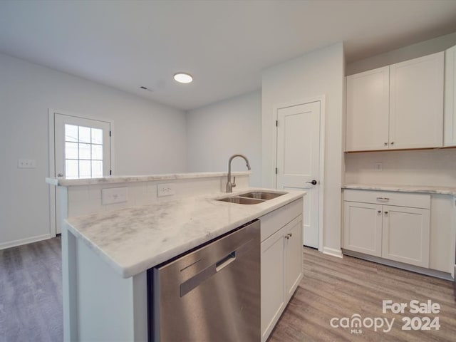 kitchen with stainless steel dishwasher, sink, white cabinets, and a kitchen island with sink