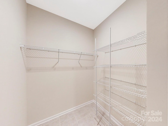 spacious closet with light tile patterned floors