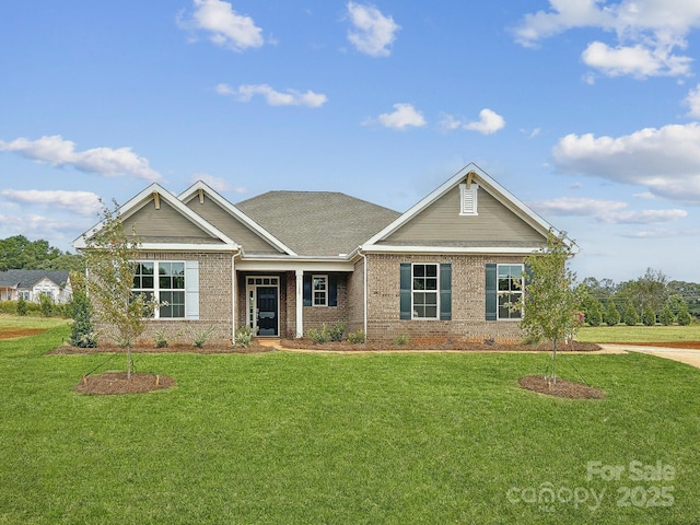 view of front of home with a front lawn and brick siding