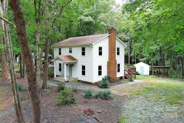 view of front property featuring a shed