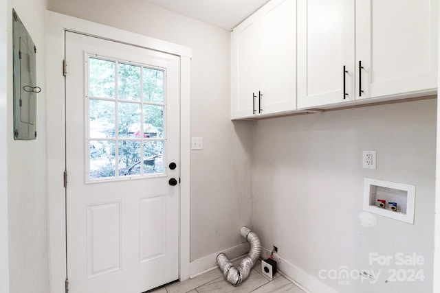 washroom featuring washer hookup and cabinets