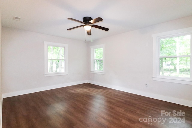 spare room with ceiling fan and dark hardwood / wood-style floors