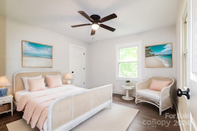 bedroom with ceiling fan and dark hardwood / wood-style floors