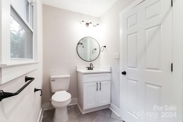 bathroom featuring vanity, toilet, and tile patterned flooring