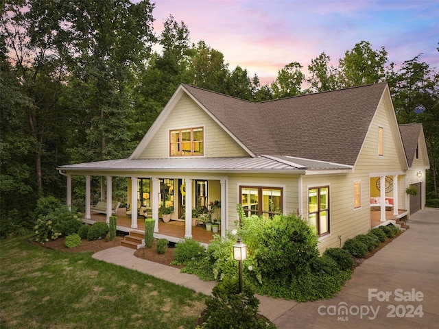 view of front of property featuring a lawn and covered porch