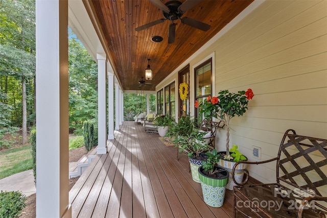 wooden terrace featuring ceiling fan and covered porch