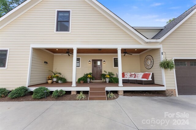 view of front facade featuring ceiling fan, an outdoor hangout area, a garage, and a patio