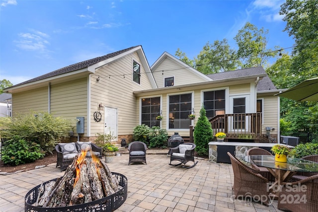 back of house with a patio area and an outdoor fire pit