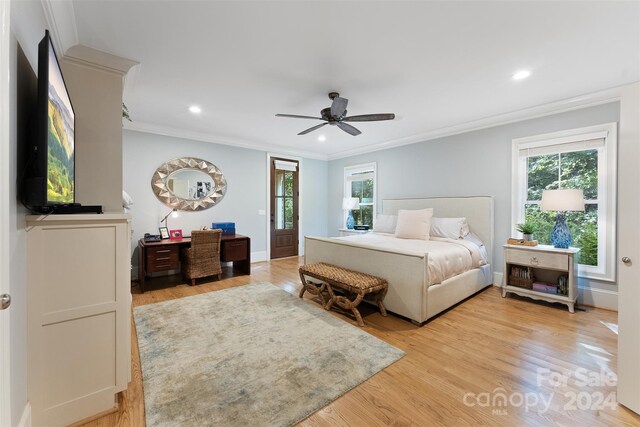 bedroom featuring light wood-type flooring, crown molding, and ceiling fan