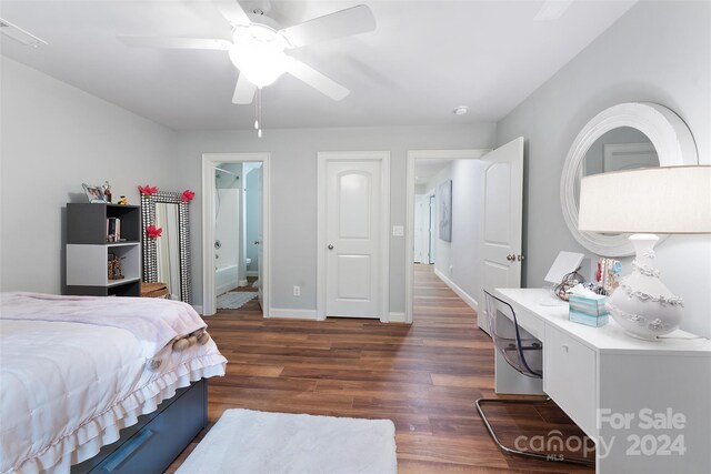 bedroom with ceiling fan, connected bathroom, and dark hardwood / wood-style flooring