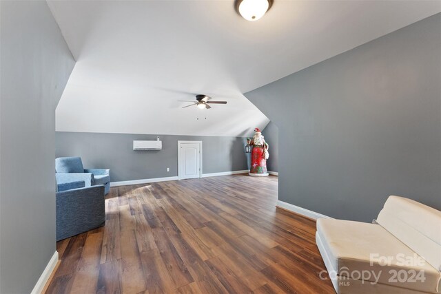 bonus room featuring dark hardwood / wood-style flooring, a wall unit AC, ceiling fan, and lofted ceiling