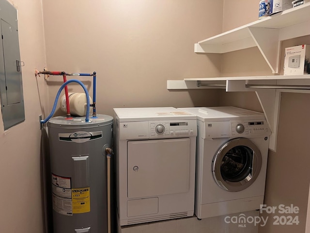 clothes washing area featuring electric panel, separate washer and dryer, electric water heater, and laundry area