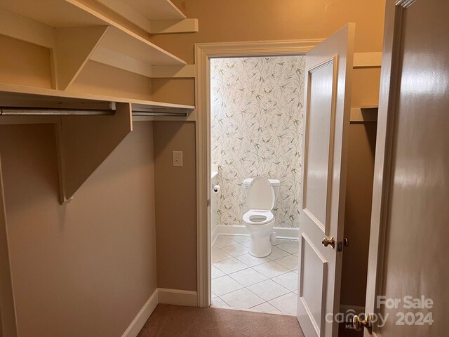 spacious closet with light tile patterned floors