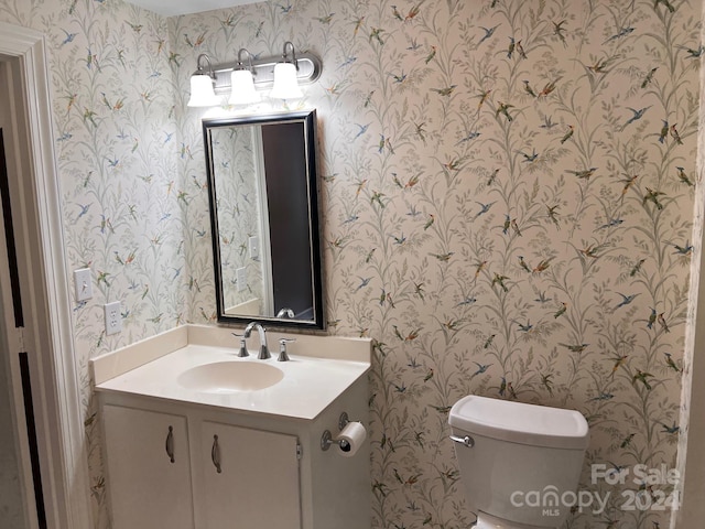 bathroom featuring toilet and vanity