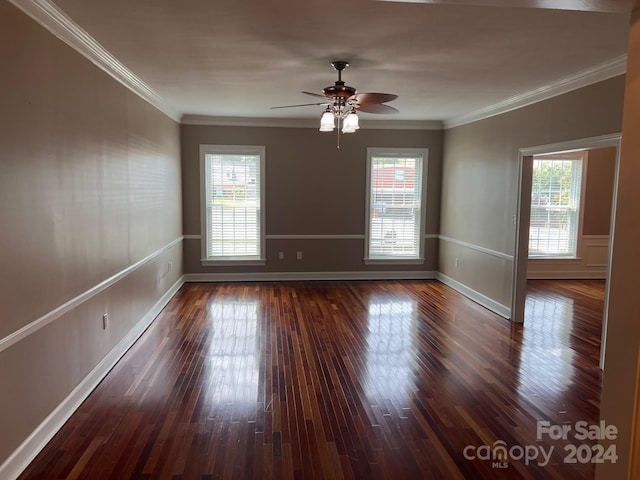 empty room featuring ceiling fan, wood finished floors, baseboards, and ornamental molding