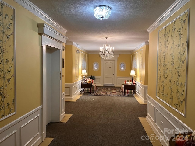 hallway with a notable chandelier, ornamental molding, a textured ceiling, and carpet floors