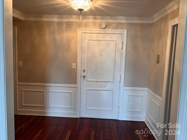 interior space with dark wood-style floors, wainscoting, and ornamental molding