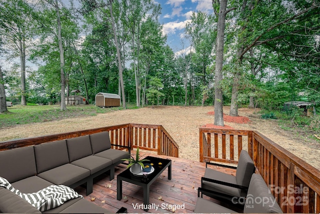 wooden terrace with a storage unit and outdoor lounge area