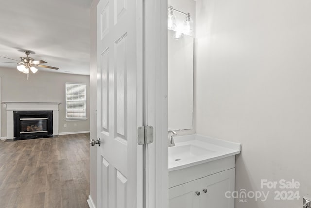 bathroom with ceiling fan, vanity, and hardwood / wood-style flooring