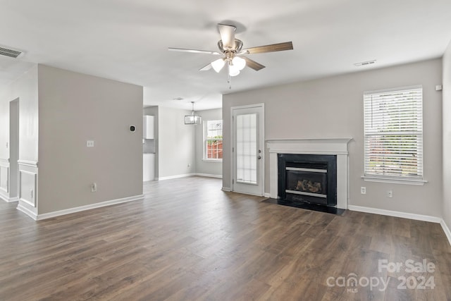 unfurnished living room featuring dark hardwood / wood-style flooring and ceiling fan