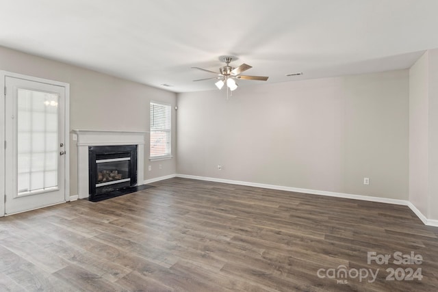 unfurnished living room featuring wood-type flooring and ceiling fan