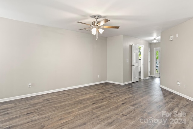 unfurnished room with dark hardwood / wood-style flooring and ceiling fan