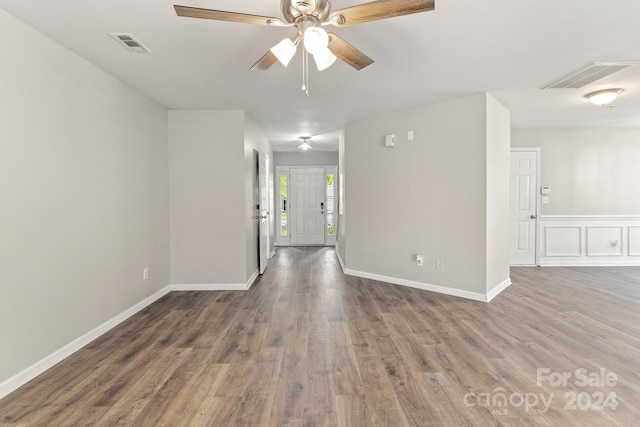 unfurnished room with dark hardwood / wood-style floors and ceiling fan