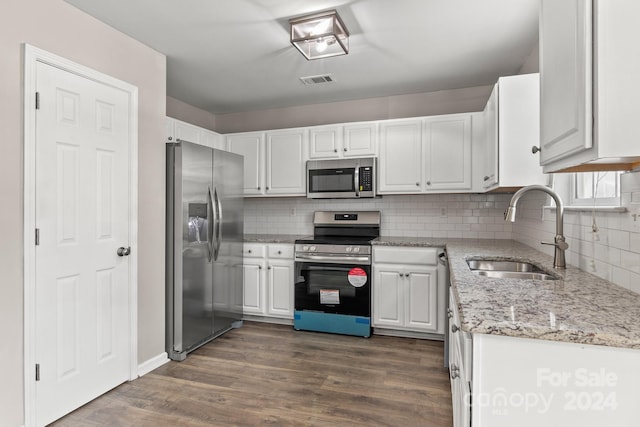 kitchen featuring white cabinets, appliances with stainless steel finishes, sink, and dark hardwood / wood-style flooring