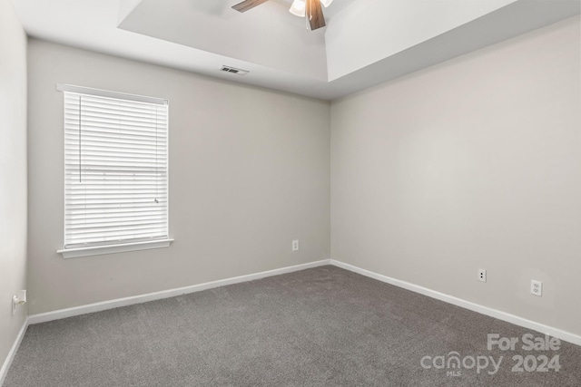 carpeted spare room featuring ceiling fan